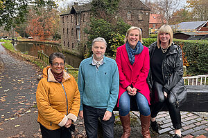 Lisa with local Lib Dem councillors sat beside Marple Locks.