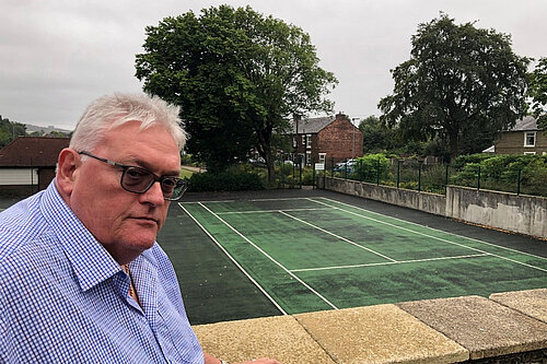 Cllr Howard Sykes OBE, at the unfinished Dunwood tennis courts