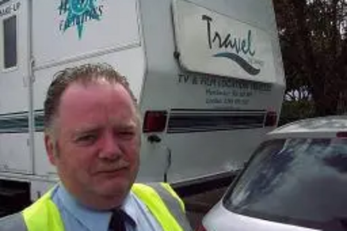 A BBC Security guard is surprised after film crew trailors were mistaken for illegal travellers' caravans