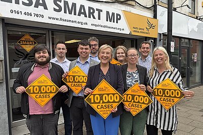 Lisa Smart MP and members of her office team mark 10,000 cases outside her Romiley Constituency Office
