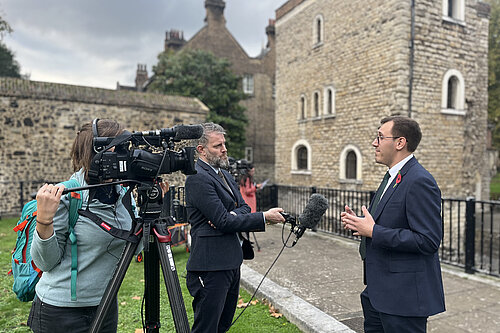 Tom Gordon stood on College Green near the houses of Parliament talking to the press