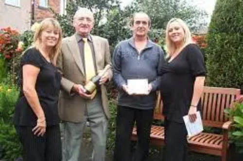 David England picks up the award on behalf of the Wild Street alley from Councillor Ted Flynn, alongside Yvonne Bennett and Diane Alletson from the Alleygating team at Rochdale Council.