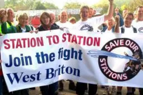 Julia Goldsworthy and Terrye Teverson marching with a save our fire stations banner
