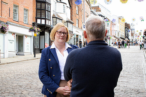 Zöe Franklin speaks with resident on Guildford High Street