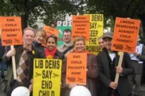 Stephen Robinson and other Lib Dems at Millbank, holding banners against child poverty