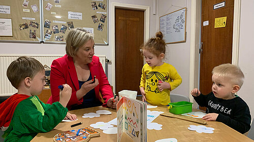 Lisa Smart sat with young nursery children