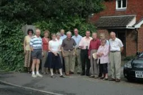 Residents standing on the site of the proposed development