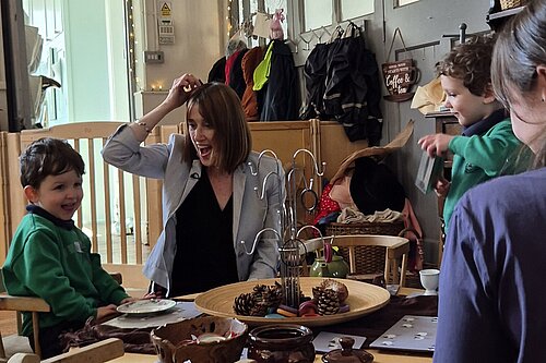 Jane Dodds MS at a nursery visit with children and staff, they are playing with wooden toys