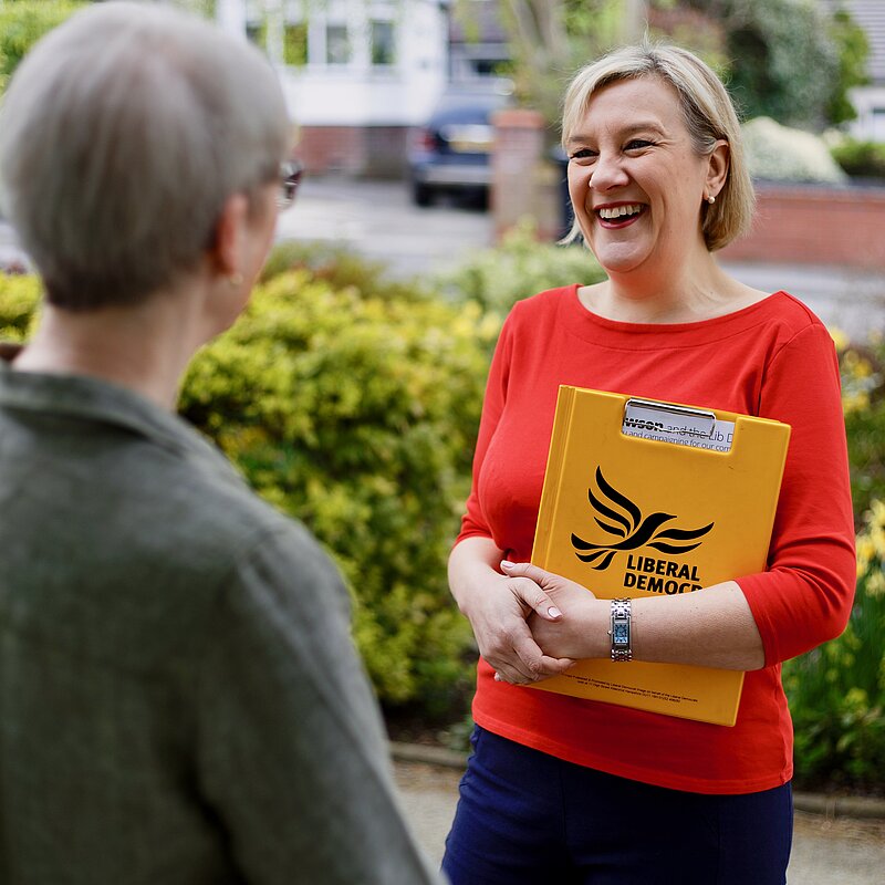 Lisa speaking to someone on the doorstep