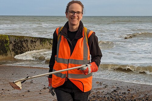 Alison helping clean a beach