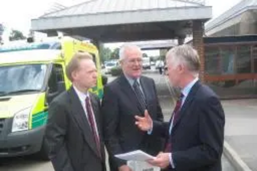 Stephen Robinson, Norman Lamb, and Peter Wilcock discussing the PFI project outside Broomfield Hospital