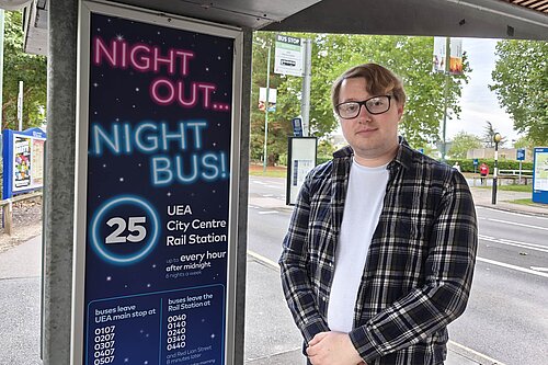Lib Dem University Ward spokesperson James Hawketts with a night bus sign at UEA. 