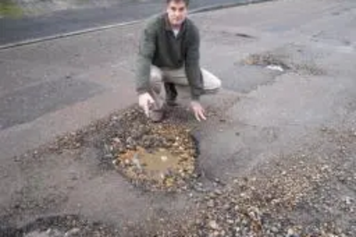 David Goodall inspects just one of the many potholes appearing on Southampton's patched road network