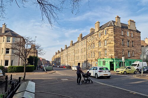 An individual with a pram trying to cross Easter Road