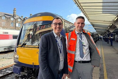 Tom Gordon stood by a train at Harrogate station