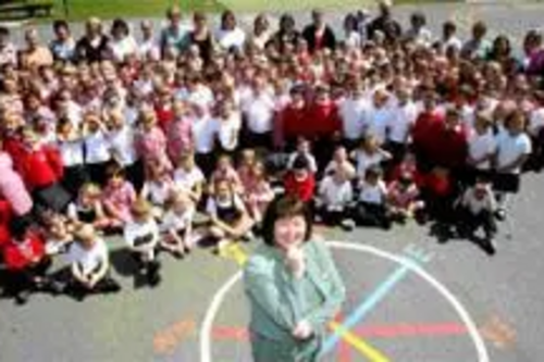 Headteacher Penny Orme, pupils & staff celebrate their success