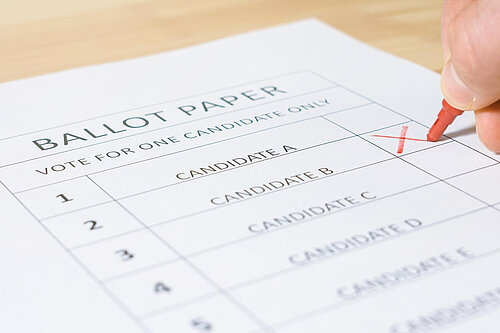 A mockup ballot paper with an X being marked next to a candidate