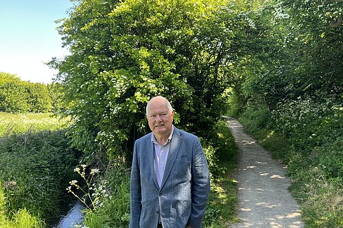 Malcolm Bond standing front of the stream at Cut Throat Dene, Seaburn