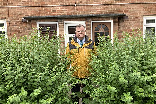 Cllr Waller with one of the overgrown hedges on Ascot Way