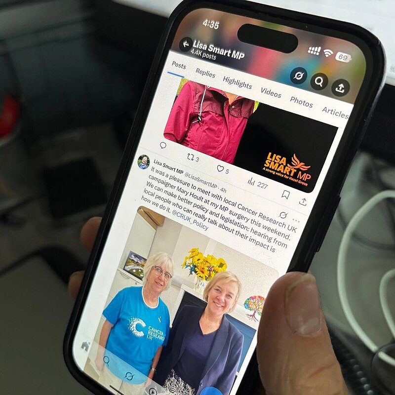 Person scrolling Lisa's social media