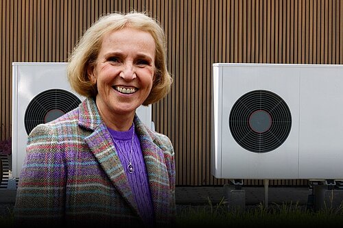 A photo of Susan Murray next to heat pumps with the following text below. Challenging heat pump myths with Susan Murray MP. 5pm 16th Jan. Sign Up.