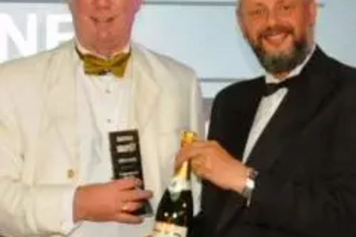 Paul Rowen receives his award and champagne from Howard Johnston, Editor-in-Chief of Tramways & Urban Transit.