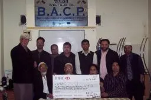 Paul Rowen presents the £4,000 cheque to members of the Bangladesh Association and Community Project