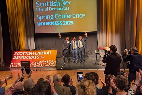 Alex Cole-Hamilton, Jamie Greene and Ed Davey taking in the applause of Lib Dem members at conference.