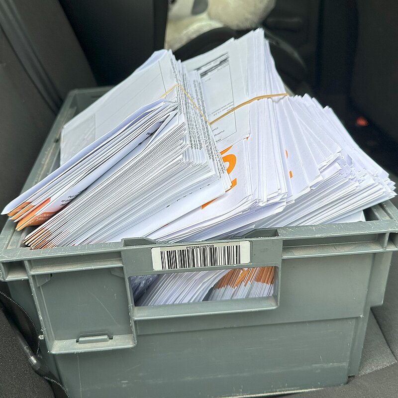 Leaflets in a box on the back seat of a car