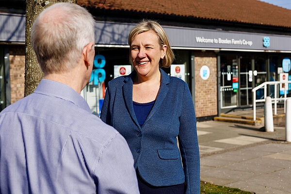 Lisa speaking with resident outside Offerton Coop
