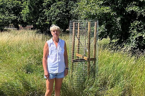 Cllr Widdowson with one of the dead trees prior to its removal