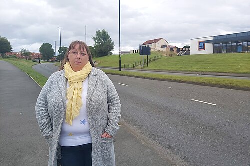Heather Fagan standing in front of a dual carriageway