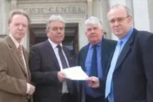 David Jones presenting bus pass petition to Mike Mackrory outside Council offices with Stephen Robinson and Keith Francis also pictured