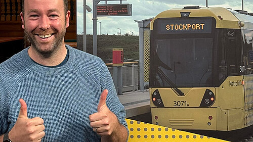 Cllr Mark Roberts, in front of a tram with Stockport on the front
