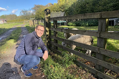 Tom Gordon next to a sheep 