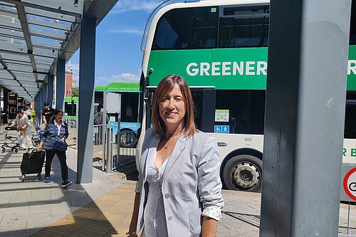 Jane Dodds MS in front of a bus