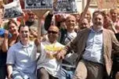 Lib Dem Councillors, activists and members of the public waggle their toes in protest at the closure of Buersil Post Office during a barefoot protest march earlier this month