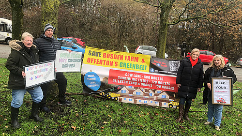 MP Lisa Smart standing with green belt protesters and their signs