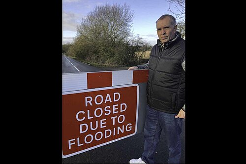 Councillor Andy Carr with flood gate