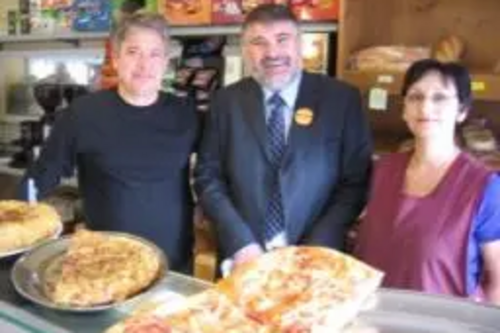 Dave Hodgson behind the bakery counter with Mr and Mrs Vecchio