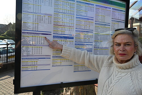 Rachel with bus timetable