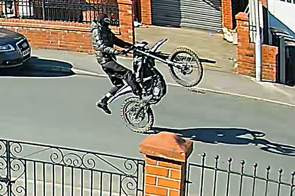 Off-road biker pulling a wheelie
