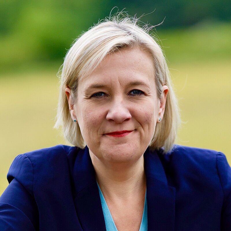 Lisa Smart MP leaning on a fence