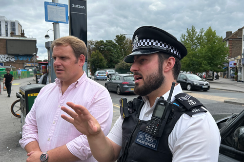Luke Taylor MP with a police officer outside Sutton Station