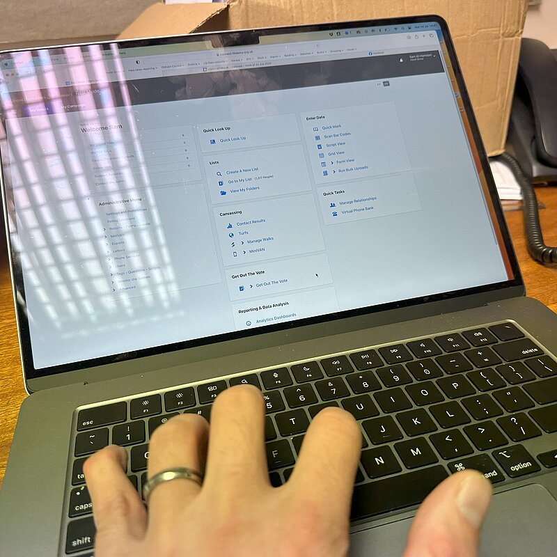 Hand typing on a laptop