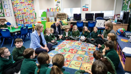 Lisa Smart and Sir Ed Davey with school children in a classroom. Copyright: Kenny Brown | Manchester Evening News