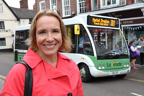 Helen standing near a bus in Market Drayton
