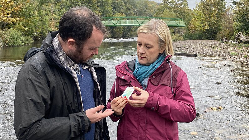Councillors Mark Roberts and Lisa Smart testing water quality in the River Goyt