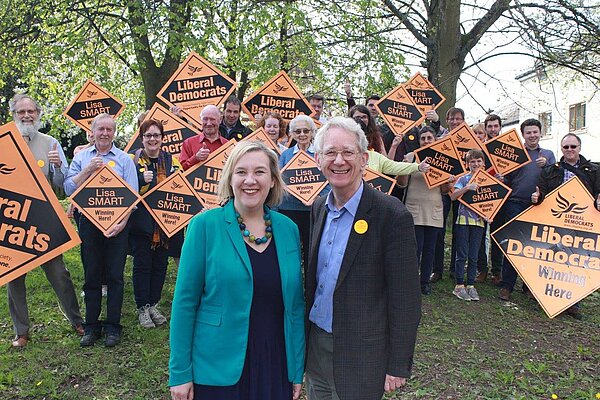 Lisa and Andrew with campaigners behind them.