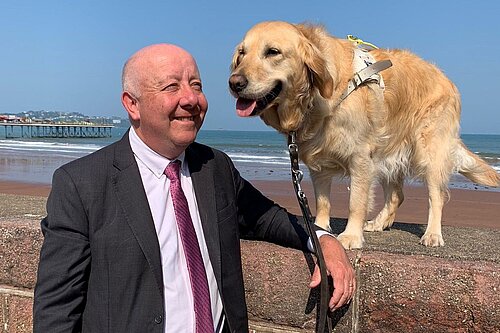 Steve Darling MP and his guide dog Jenny by the coast in Torbay